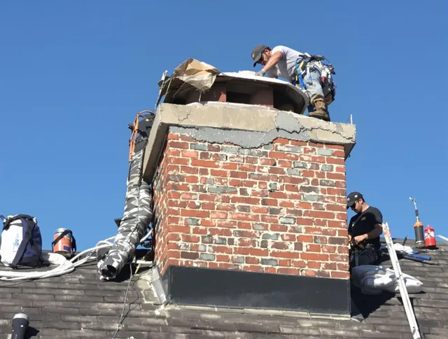 Pembroke Chimney Sweep installing a custom chimney crown in Pembroke, MA