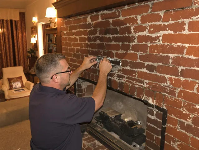 Pembroke Chimney Sweep expert fixing a fireplace in Pembroke, MA